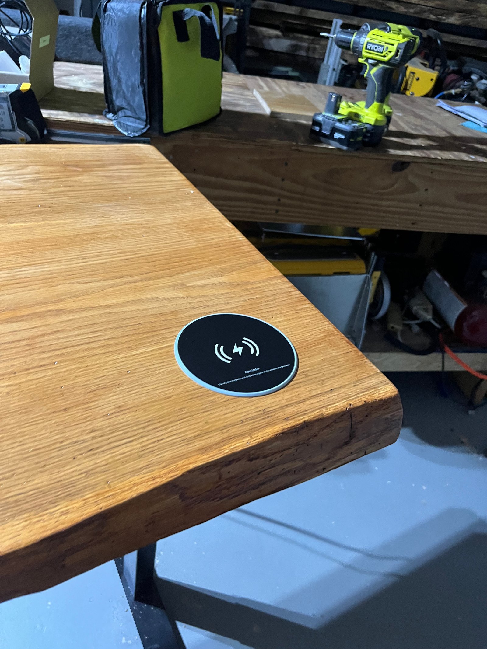 Close-up of integrated wireless charging coil inside solid wood table